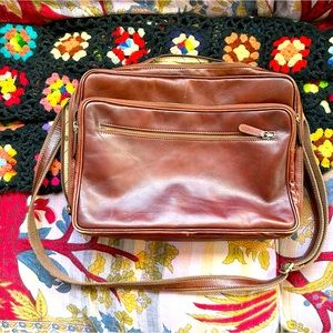 Genuine leather briefcase with zip pockets and shoulder strap